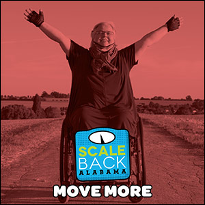 Image of a person in a wheelchair with their arms raised in the air