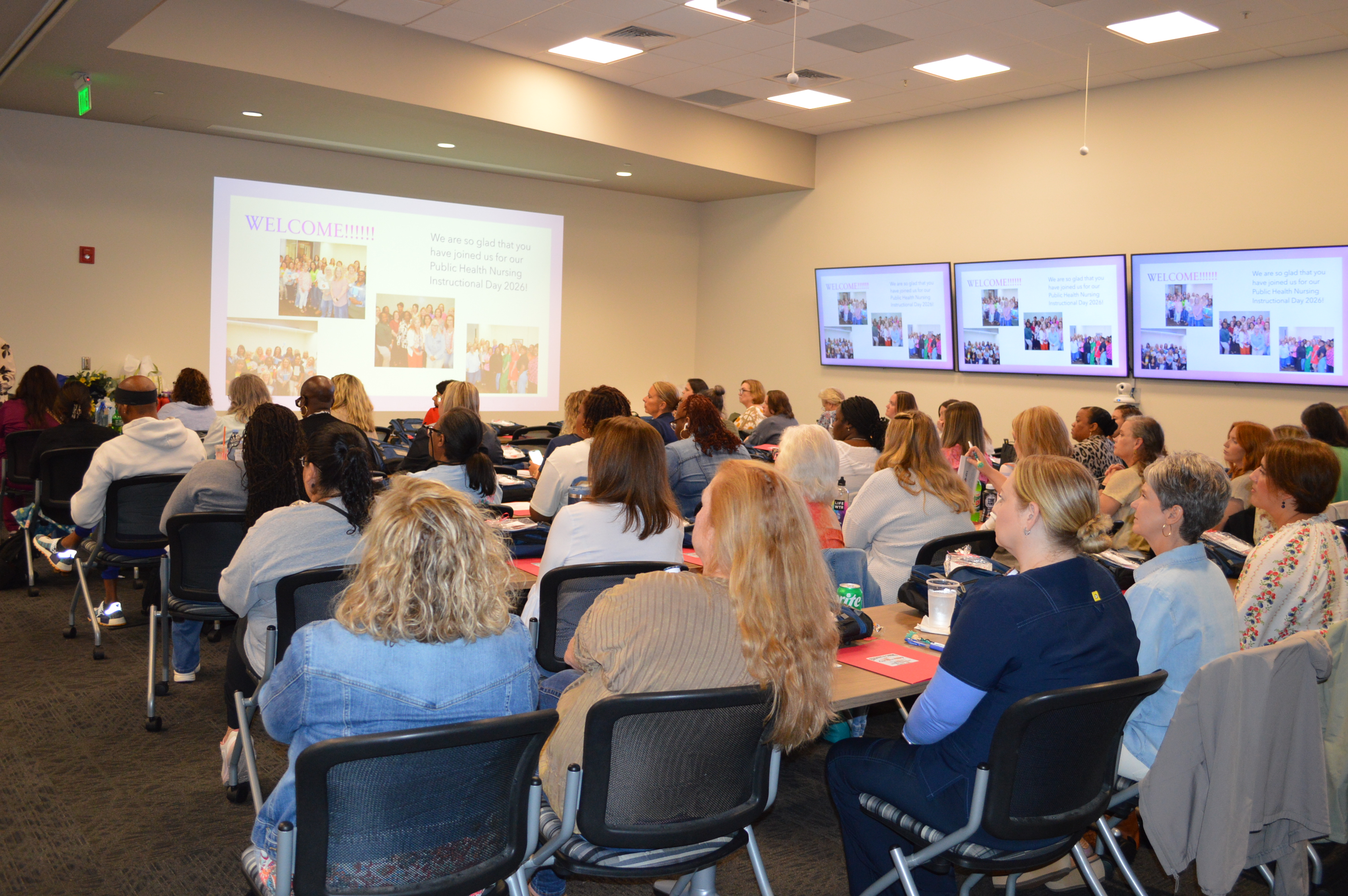 Photo of a group of nurses and clinical aides seated together in a conference room.