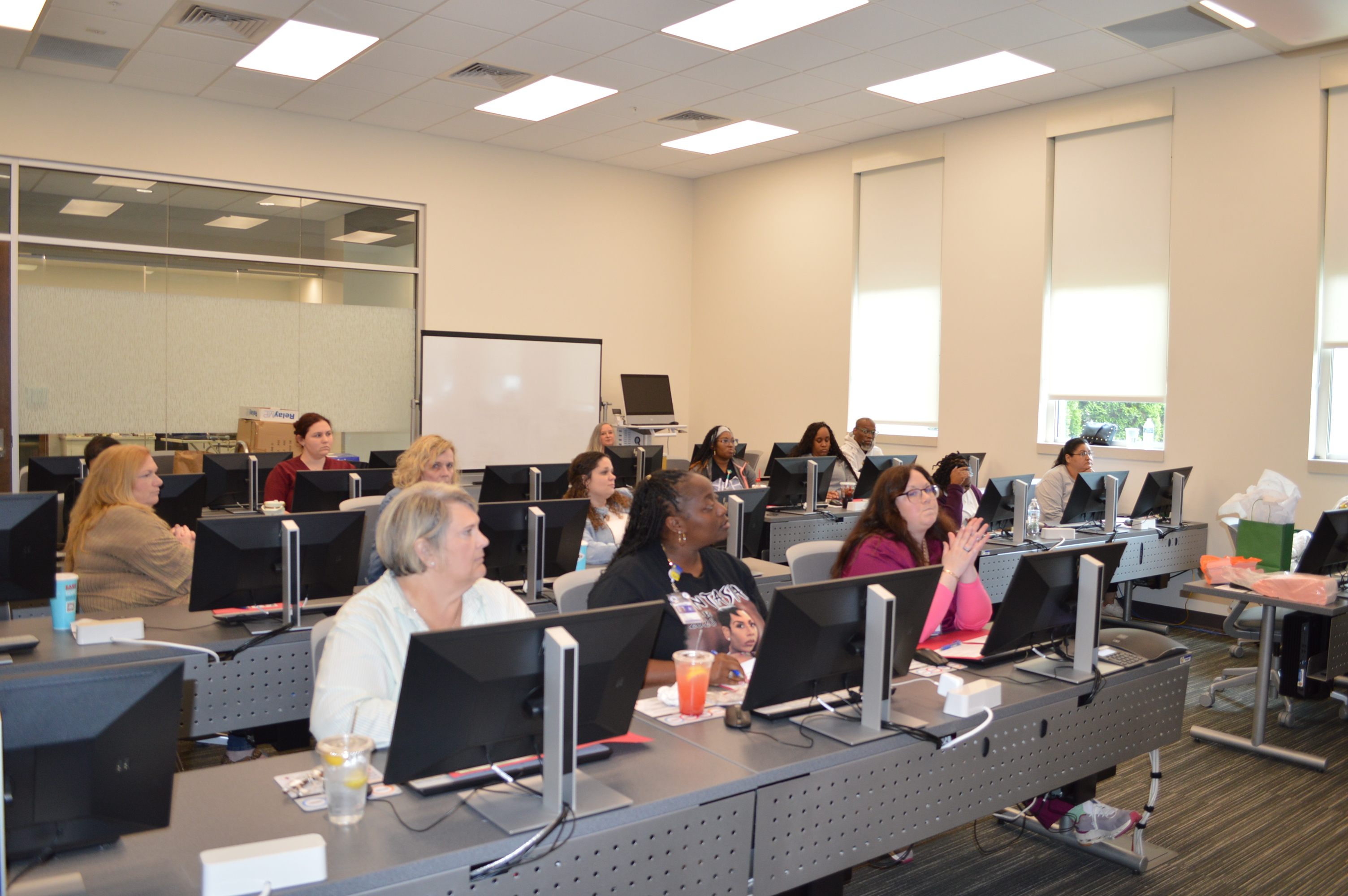Photo of a nurses and clinic aides sitting at desks.